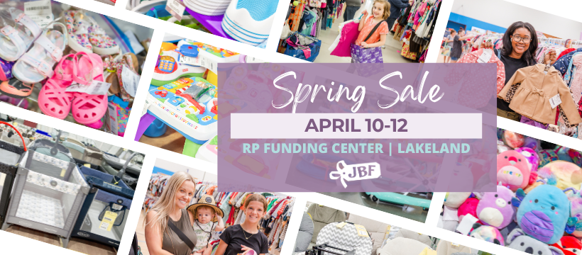 A mom and her child hug in between two rows of little girl clothes